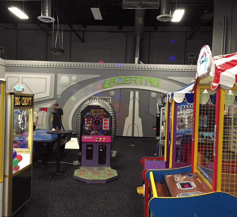 Claw machine and arcade games at Quest for Directions amusement center. Family fun with engaging game activities.