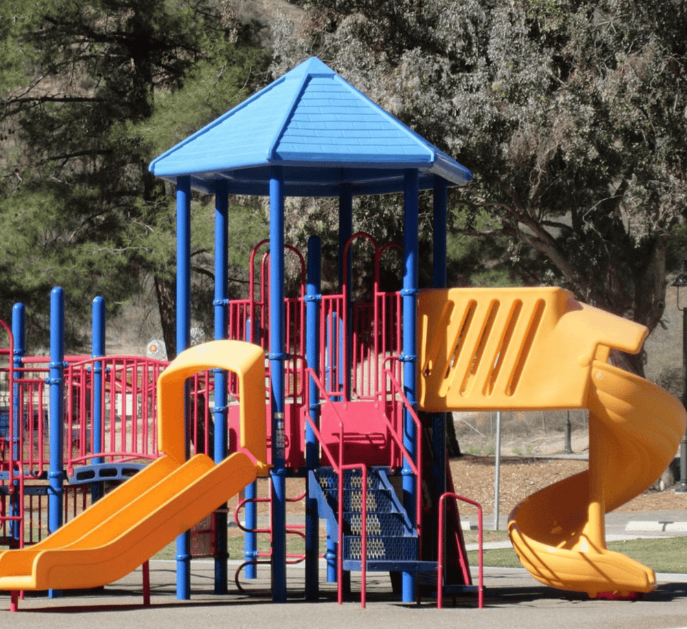 Colorful kids playground with slides and climbing structures in a park.