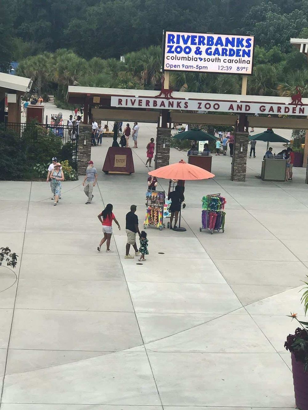 Bright entrance of Riverbanks Zoo and Garden in Columbia, South Carolina, bustling with visitors.