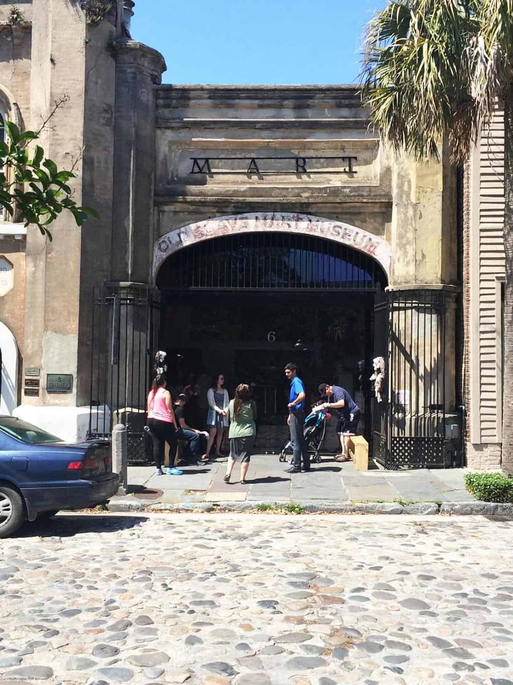 Historic building entrance with vintage architecture and a group of people outside, perfect for exploring San Francisco landmarks.