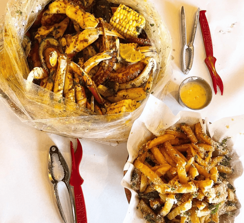 Succulent seafood boil with crab legs, corn, and sausage, perfect for seafood lovers.