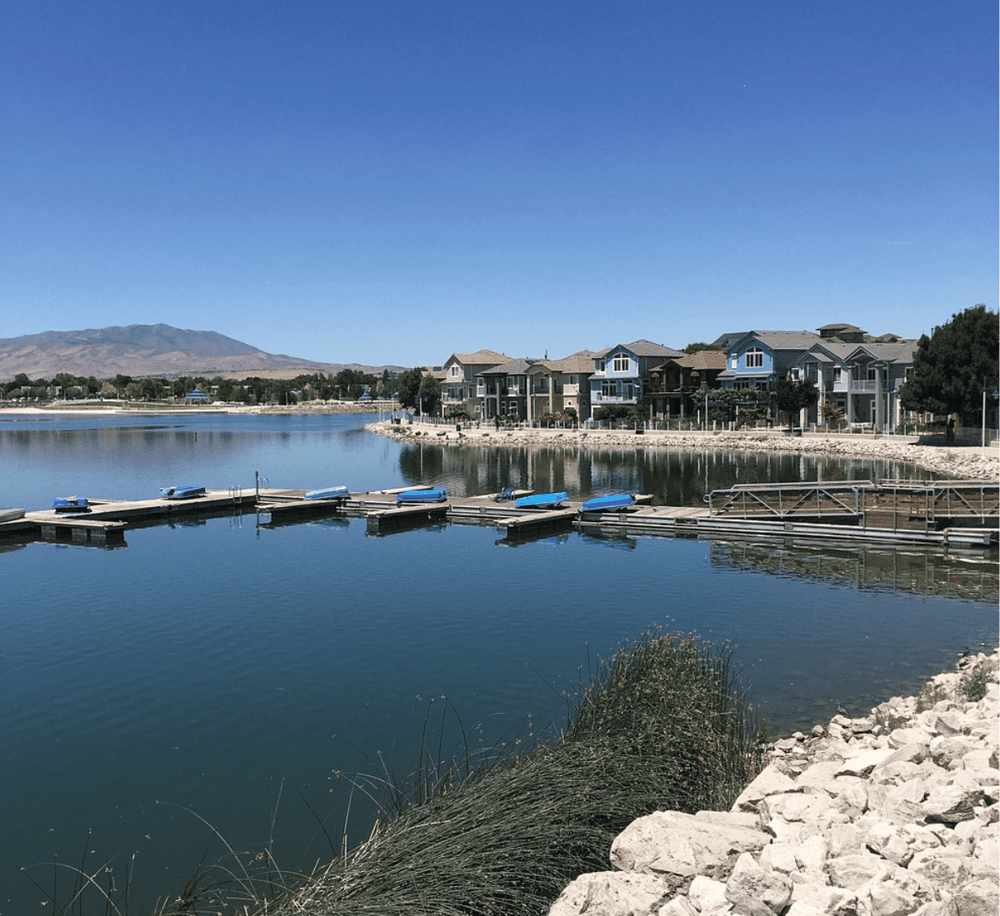 Peaceful waterfront residential community with dock and mountain views, ideal for boat lovers and nature enthusiasts.