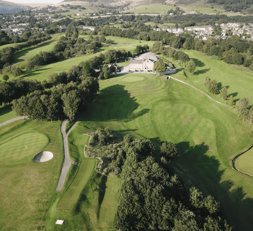 Secluded golf course with green fairways and trees, scenic landscape perfect for golf enthusiasts.