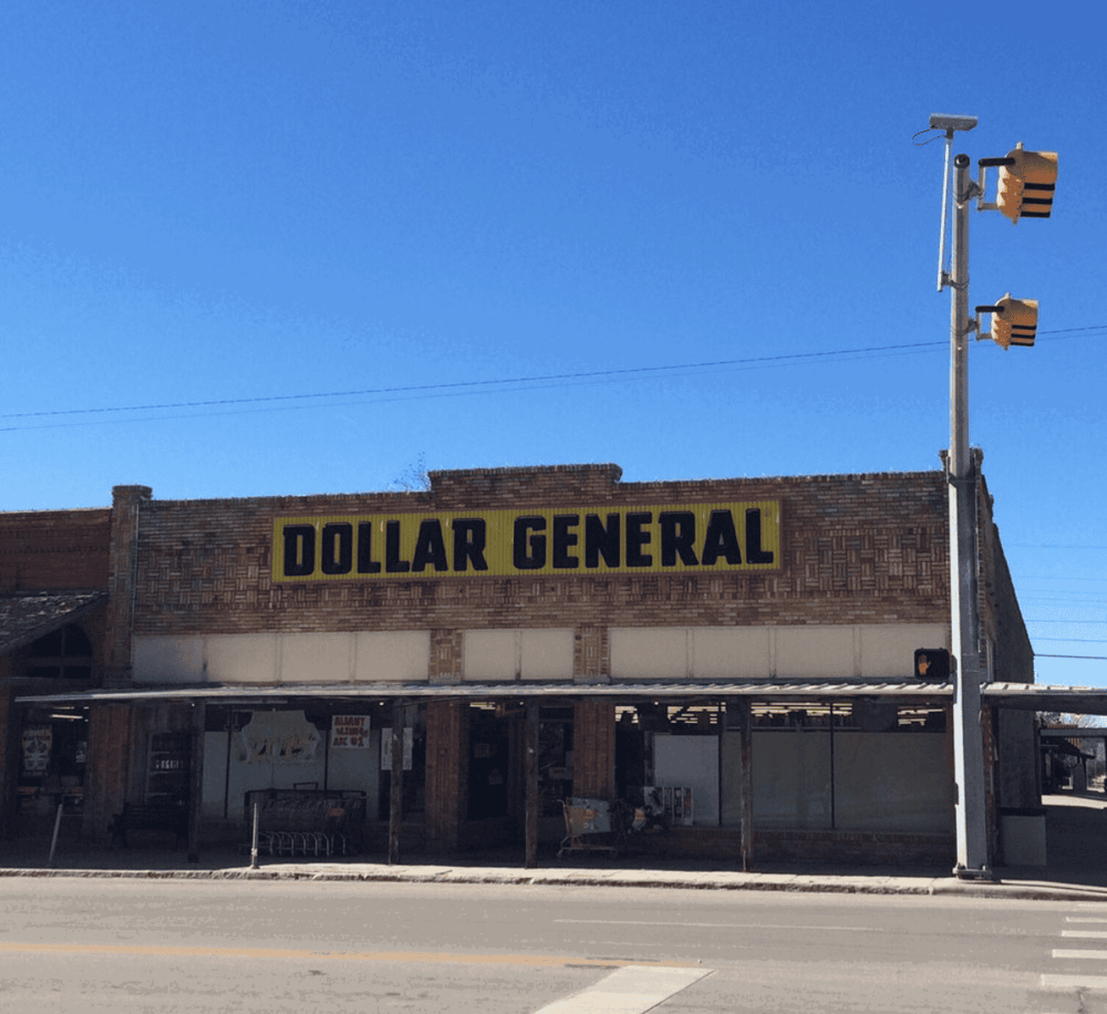 Dollar General store on main street with clear blue sky, convenient shopping and essential goods.
