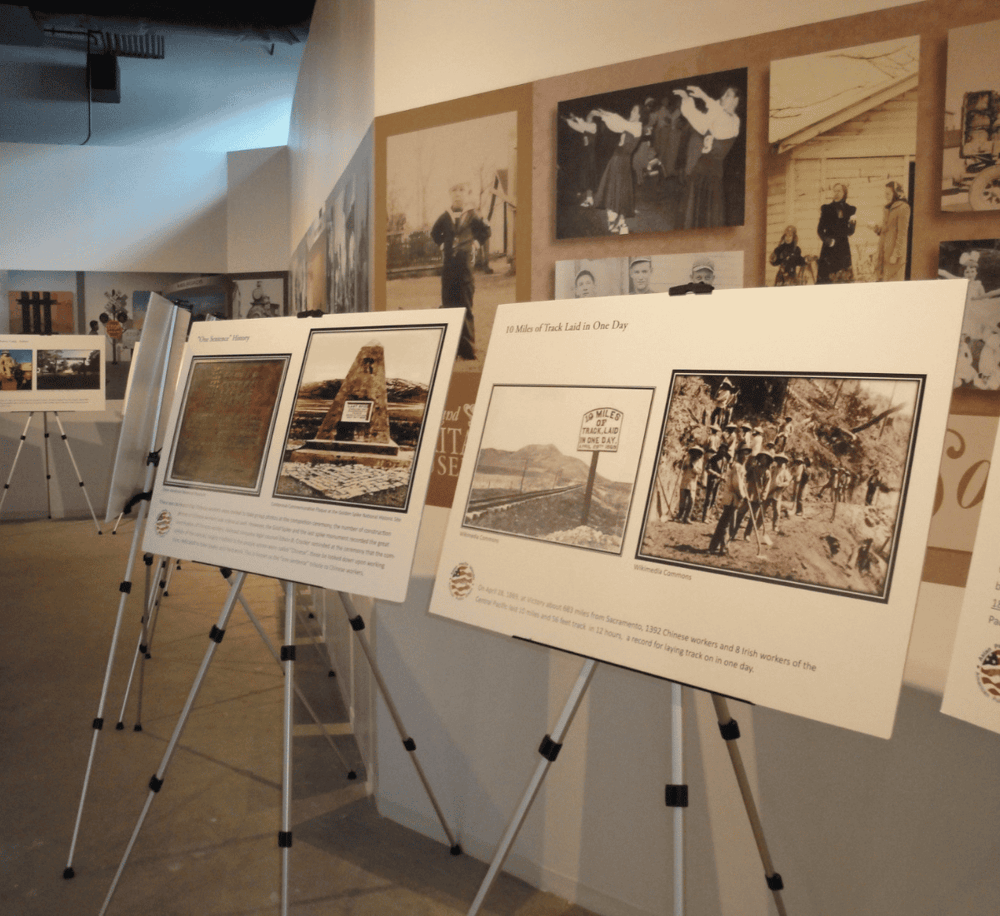 Historic photo display at QuestForDirections museum, showcasing trail history and Asian-American contributions.