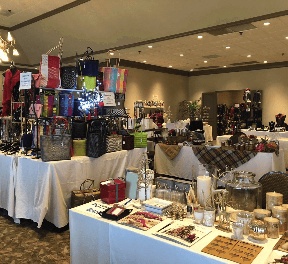 Colorful handmade bags and jewelry display at Christmas craft fair.