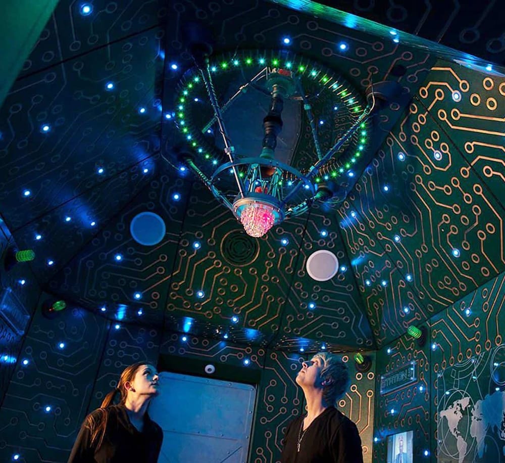 1. LED chandelier inside high-tech futuristic room with digital circuit design.