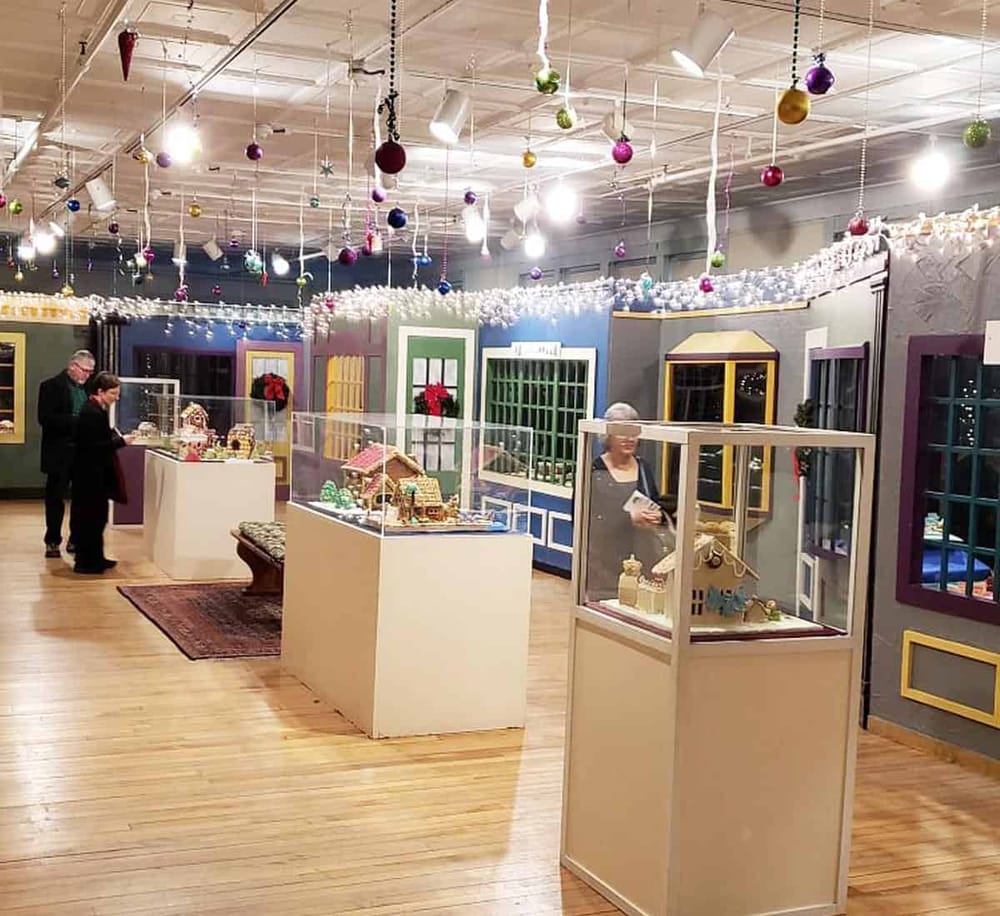 Colorful holiday-themed exhibit with miniature houses and festive decorations at QuestForDirections.