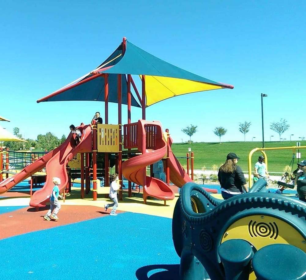 Bright playground with slides and shaded area, perfect for children’s outdoor activities and family fun.