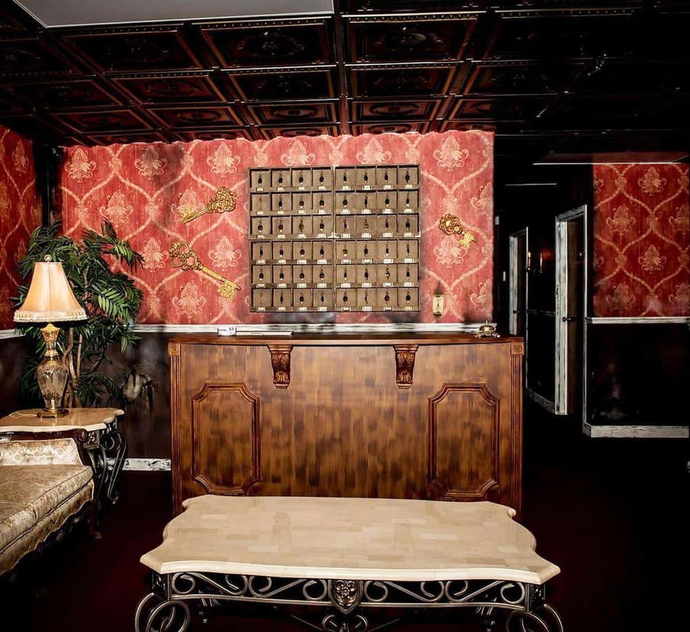 1. Vintage hotel lobby reception with classic decor and key collection behind the counter.