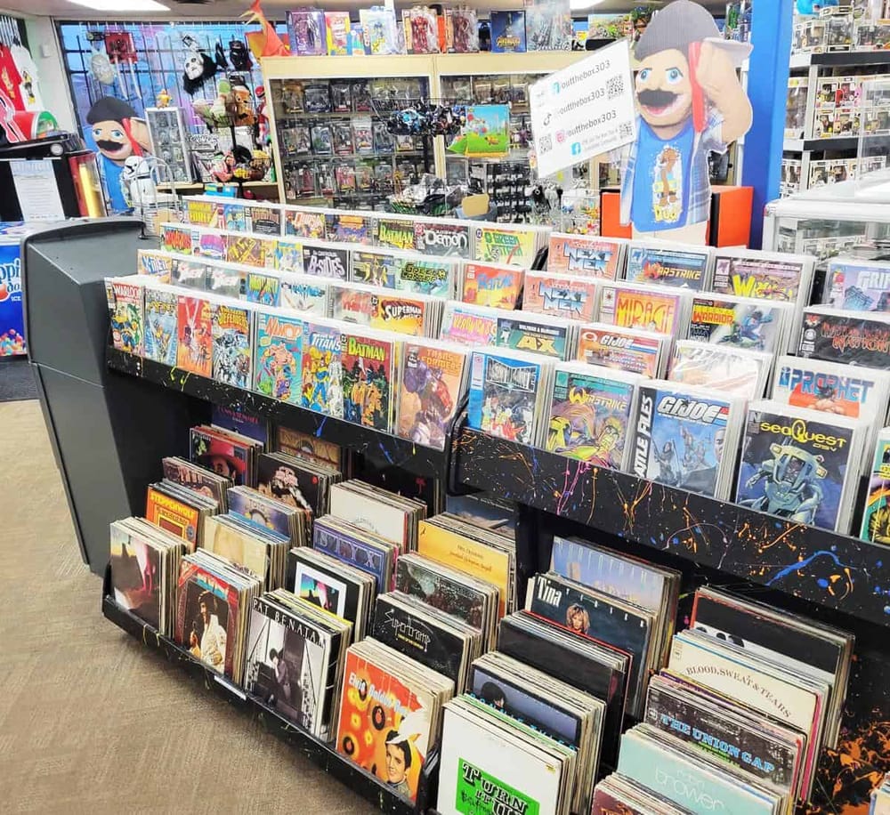 Vintage comic book rack at QuestForDirections store, featuring superhero and pop culture comics.