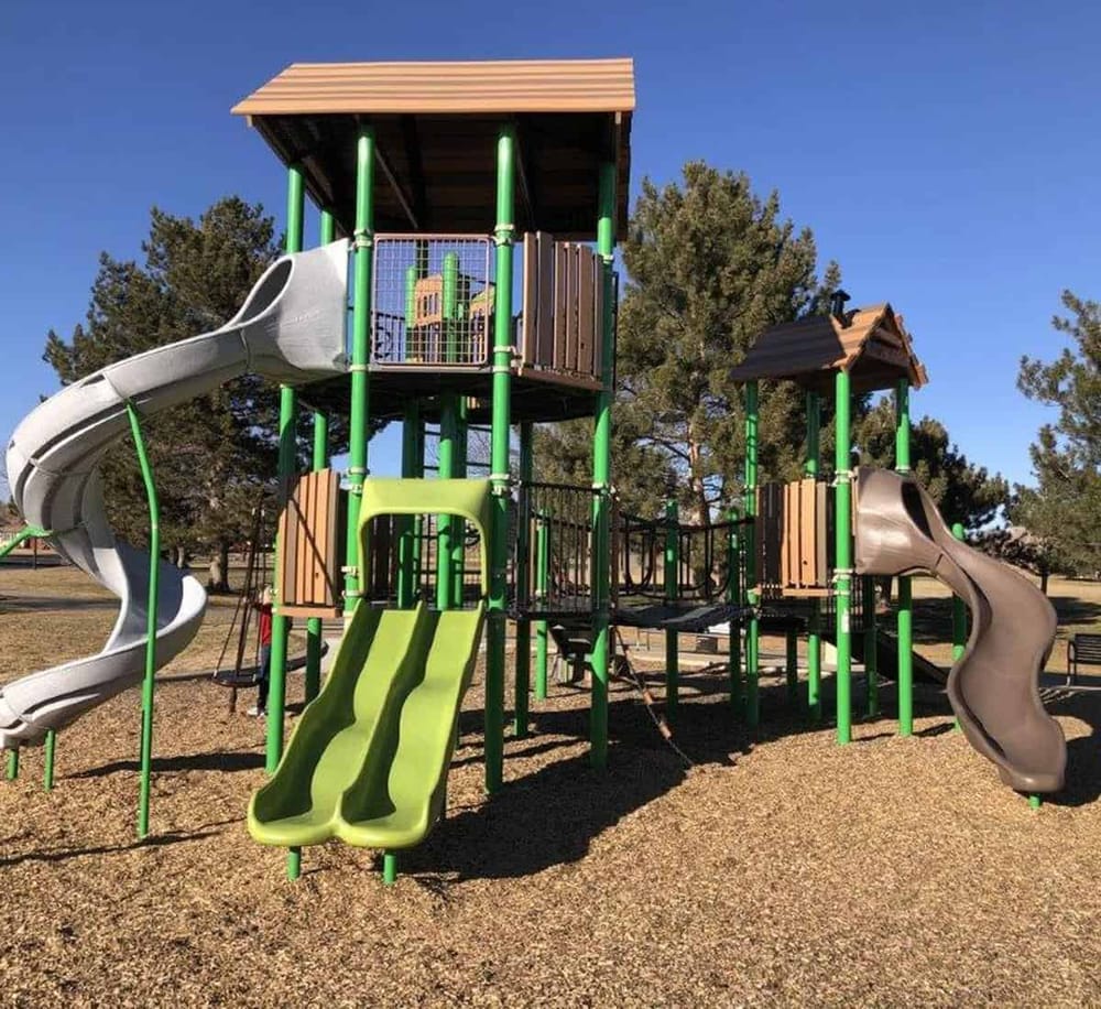 Colorful outdoor playground with slides and climbing structures, perfect for kids' recreation and family fun.