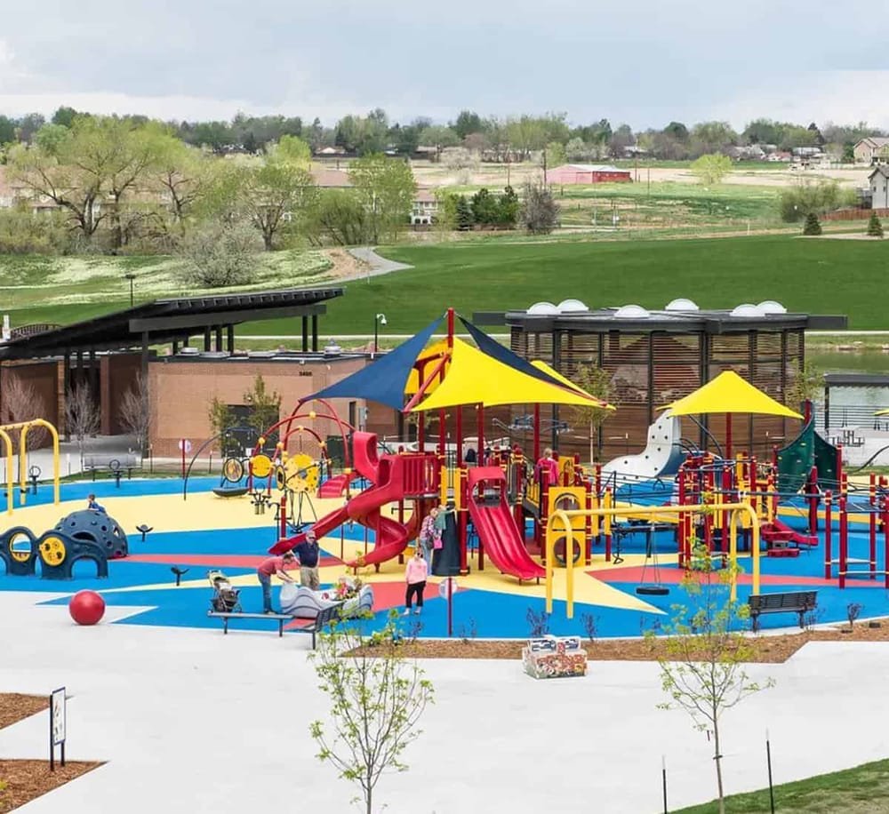 Colorful playground with slides and swings at QuestForDirections park in a scenic outdoor setting.