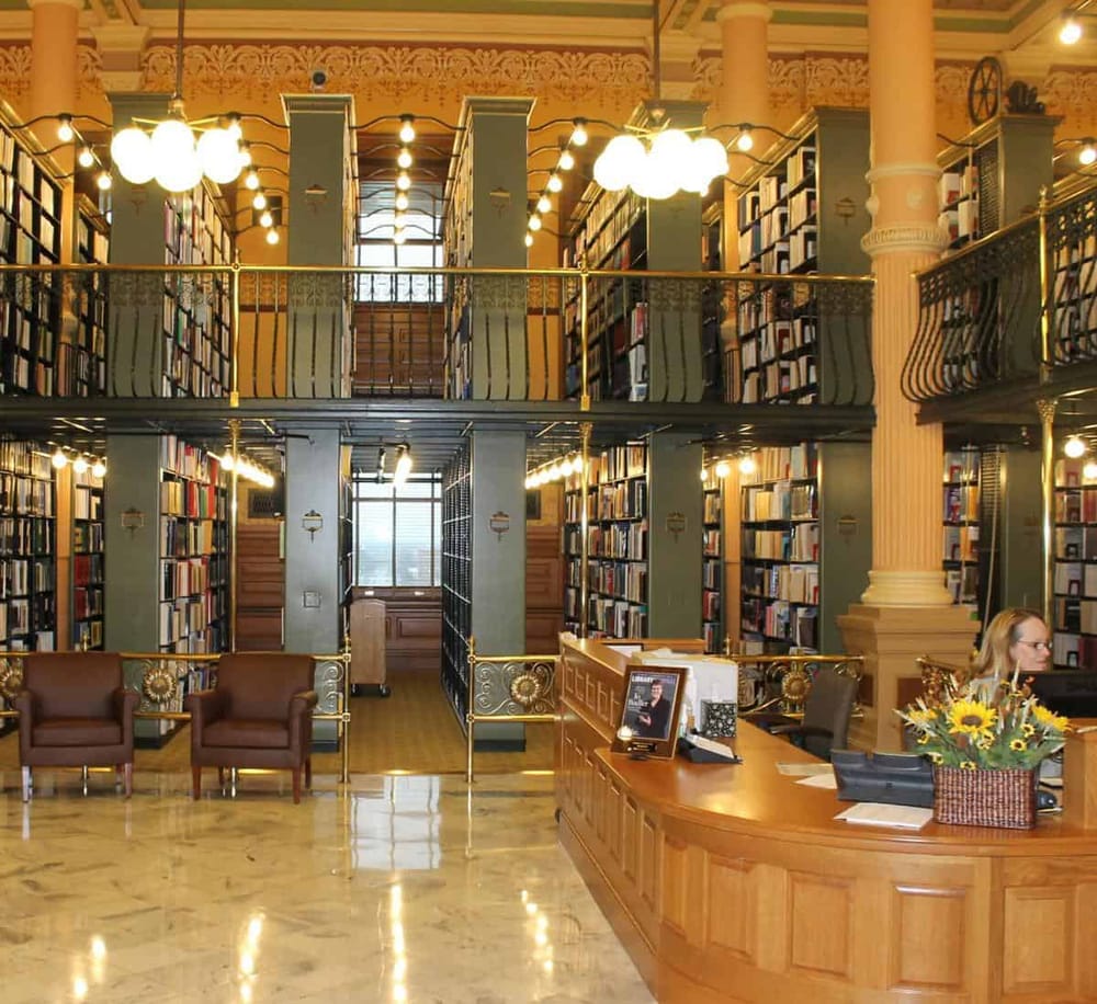 1. Elegant library interior with tall bookshelves and cozy seating areas, classic architectural details.