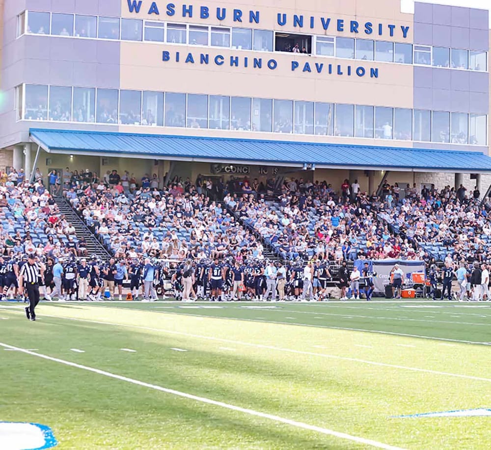 Crowd gathered at Washburn University Burchino Pavilion during a football game.