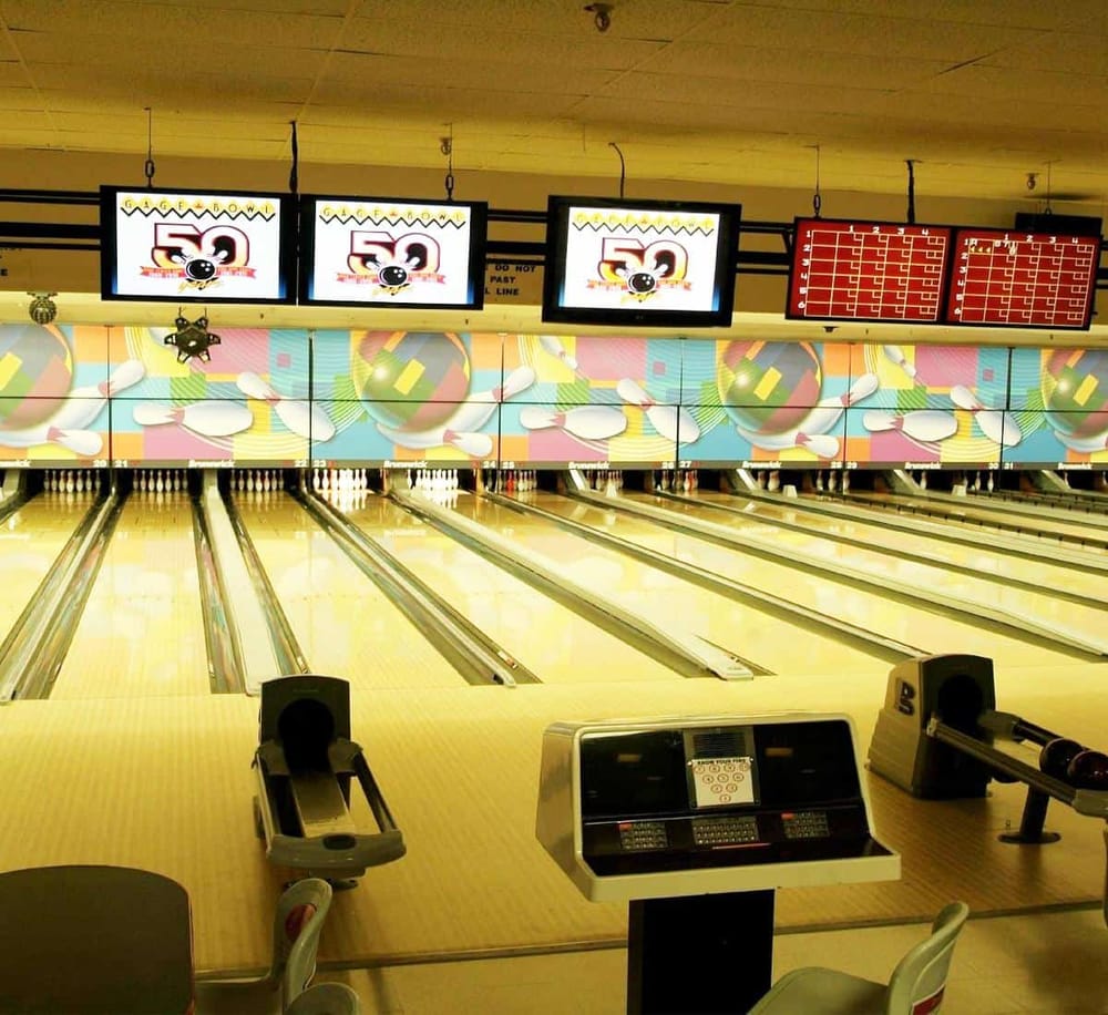 Bright bowling alley with colorful decor, electronic scoreboards, and multiple lanes for entertainment and leisure activities.