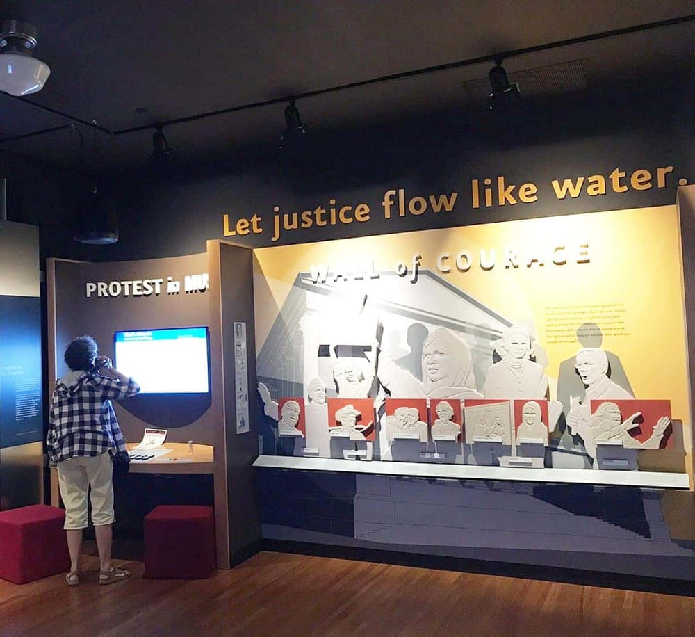 Diverse protest exhibits showcasing courage and justice at QuestForDirections museum.