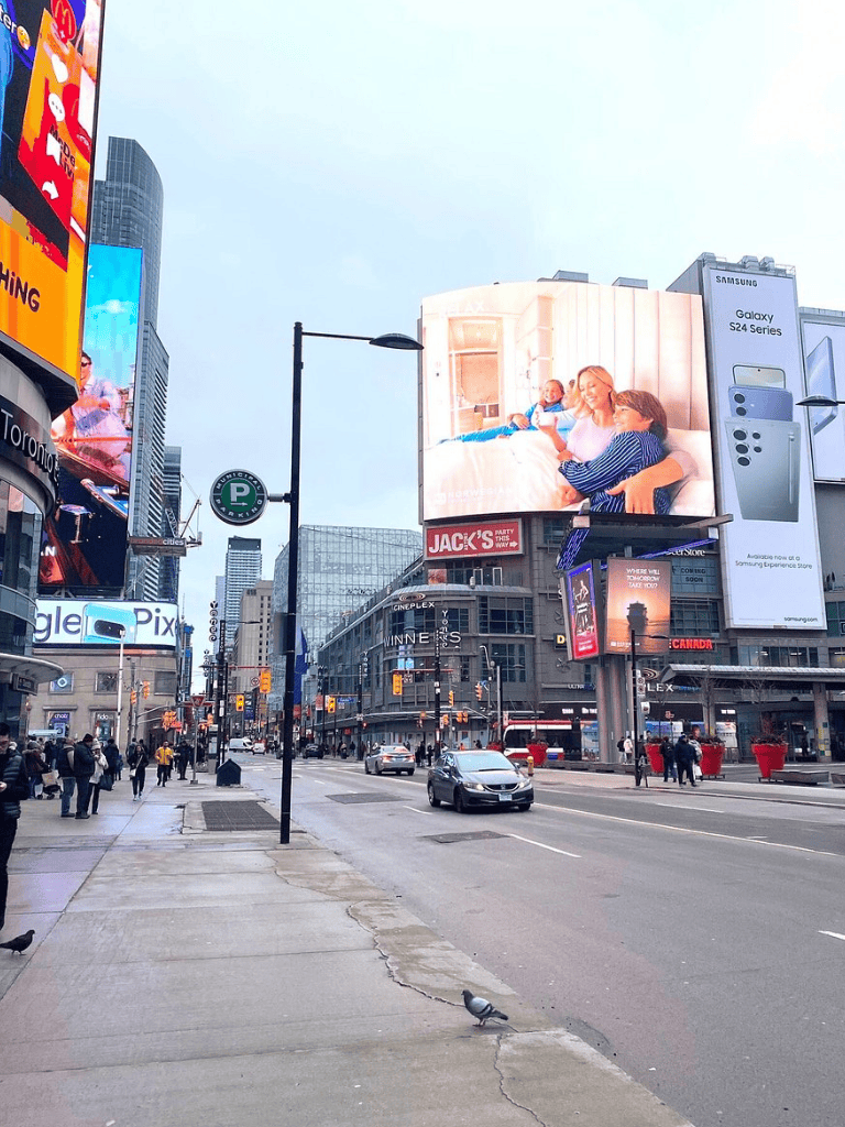 Bright Times Square in New York City with digital billboards and busy streets, showcasing urban travel and directions.