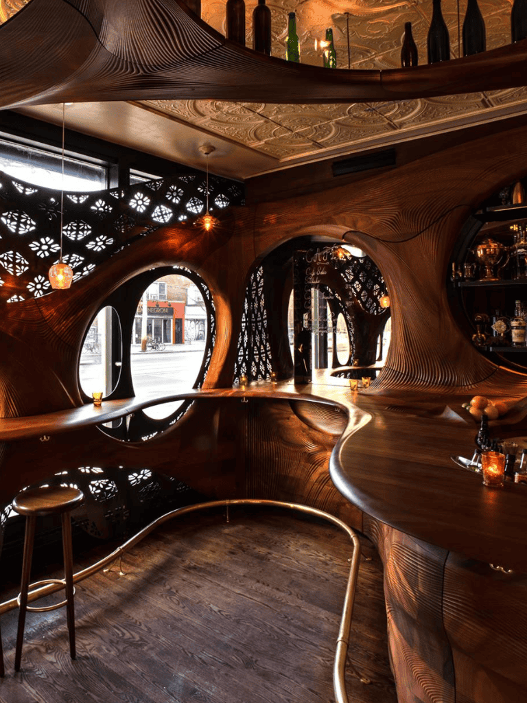 Modern stylish bar interior with unique wooden design and ambient lighting for a cozy dining experience.