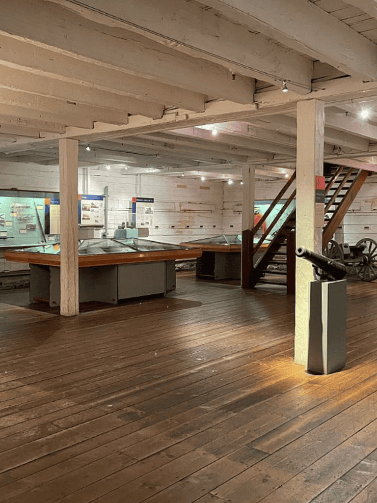 Old historic museum exhibit with display cases and antique artifacts.