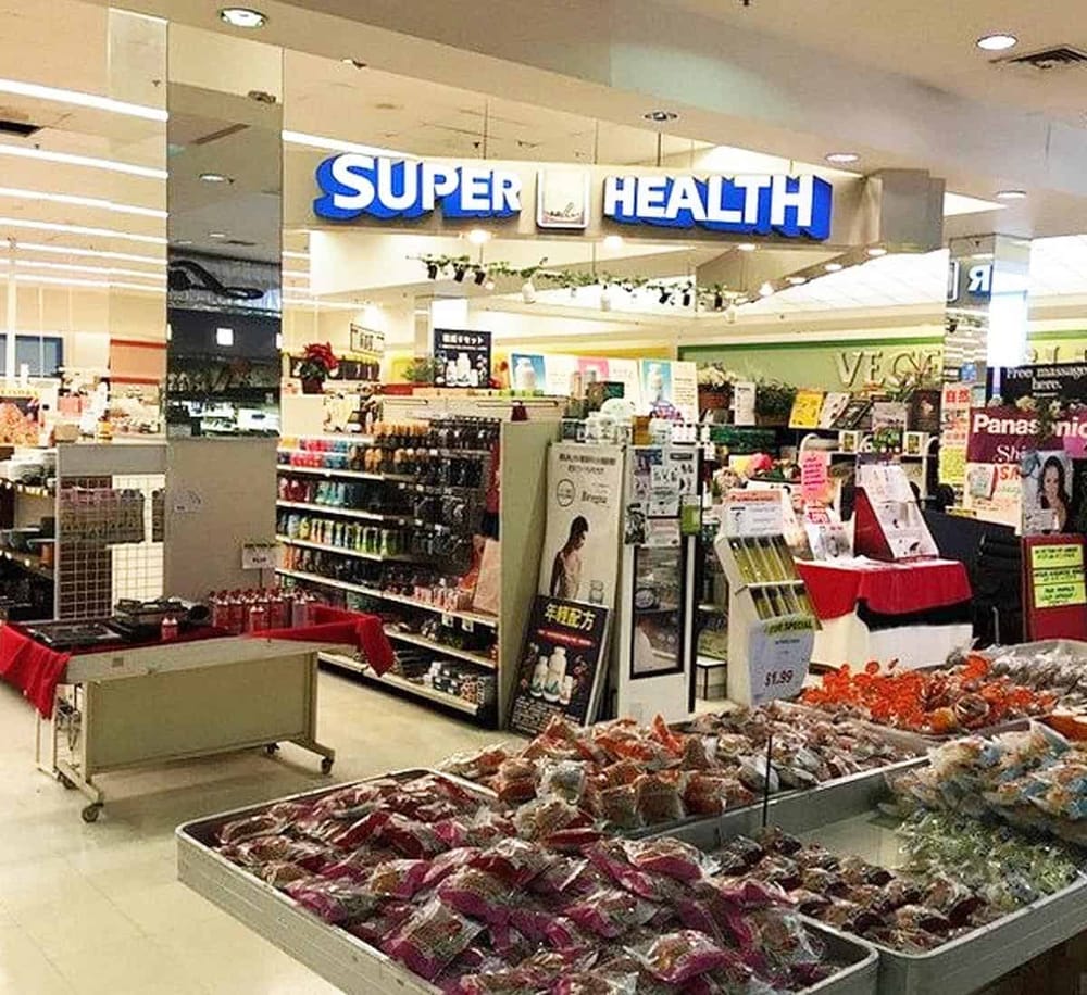 Fresh groceries and health products at Super Health store in a shopping mall.