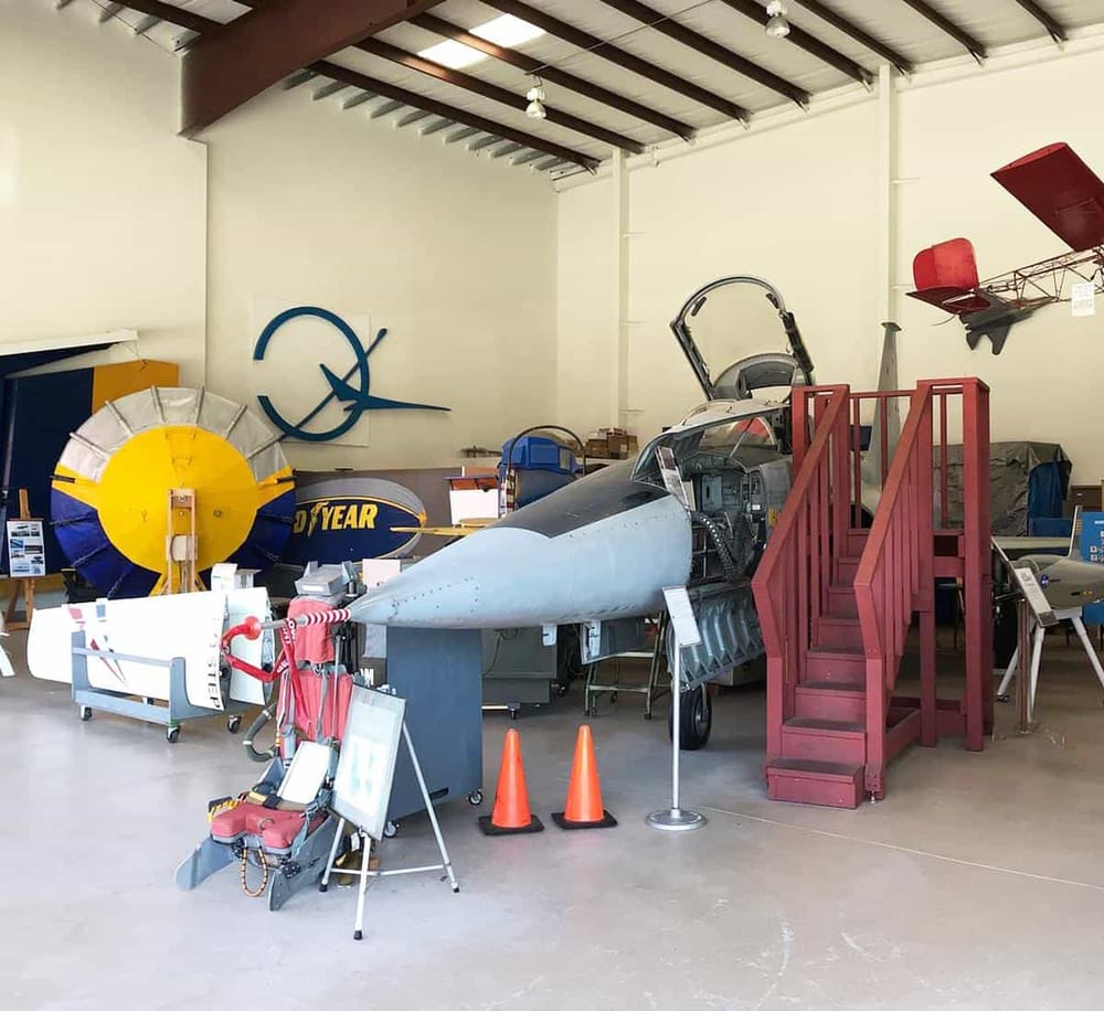 Jet fighter aircraft cockpit exhibit at QuestForDirections aviation museum, showcasing aerospace history and aircraft displays.