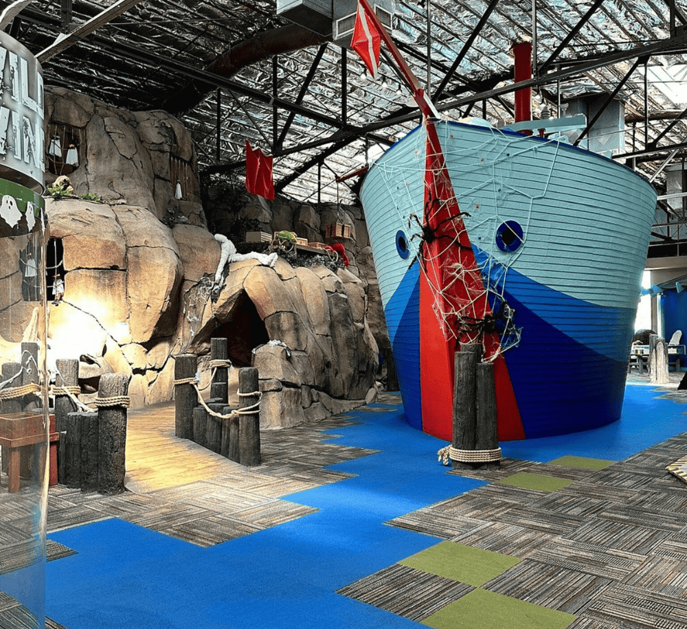 Brightly colored pirate ship display at Quest For Directions indoor amusement park.