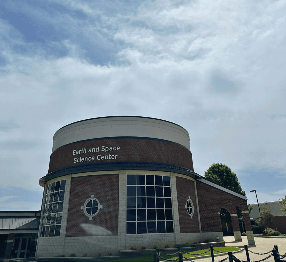 Earth and Space Science Center building on a partly cloudy day.