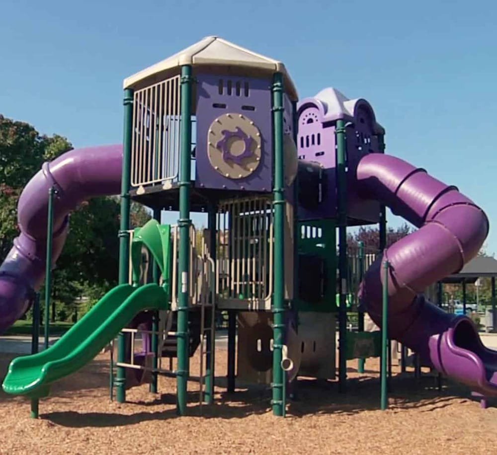Colorful playground with slides and tunnels for children.