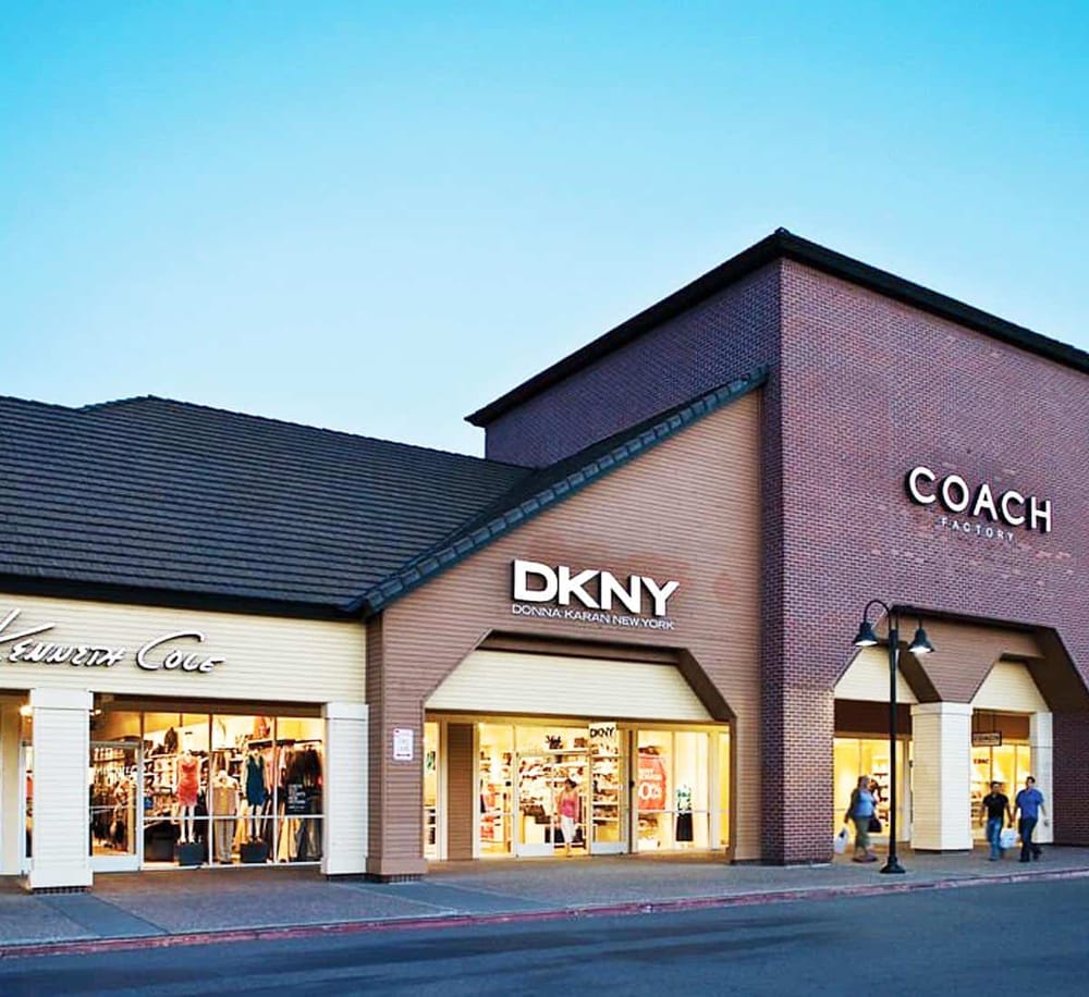 Bright retail shopping center with DKNY, Coach, and Edward Cole stores - Quest for Directions shopping mall.