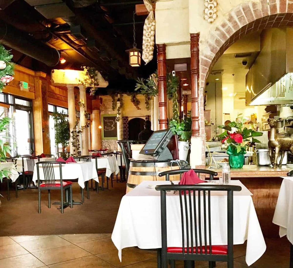 Warm cozy restaurant interior with elegant decor and festive holiday decorations.