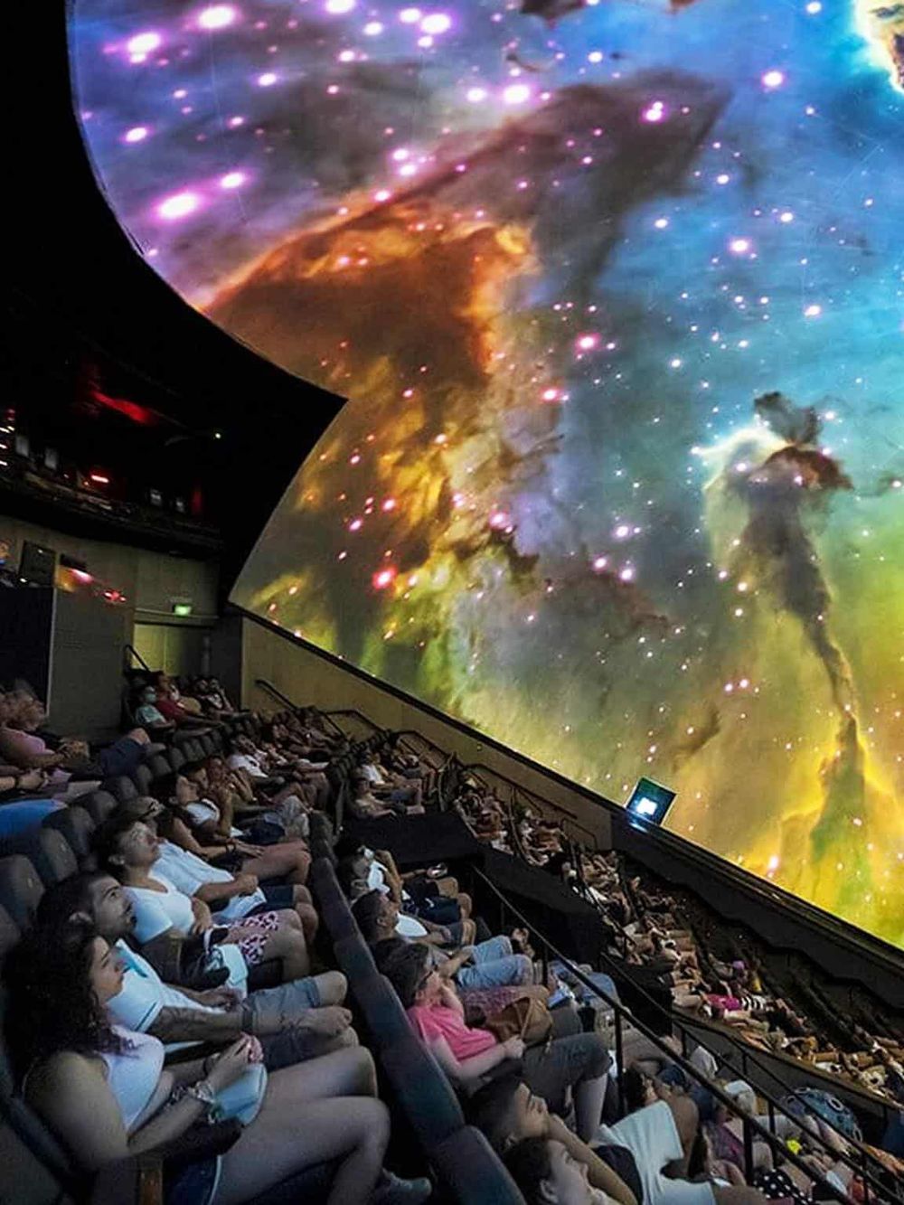 Vivid space-themed digital projection at QuestForDirections, engaging audience in a cosmic exploration experience.