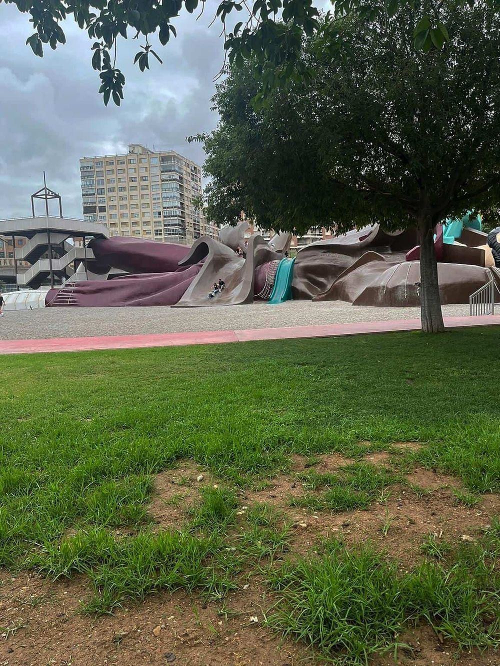 Colorful Door Sculpture in Park, Urban Playground with Modern Architecture, Popular Tourist Attraction, Bright Public Art Installation.