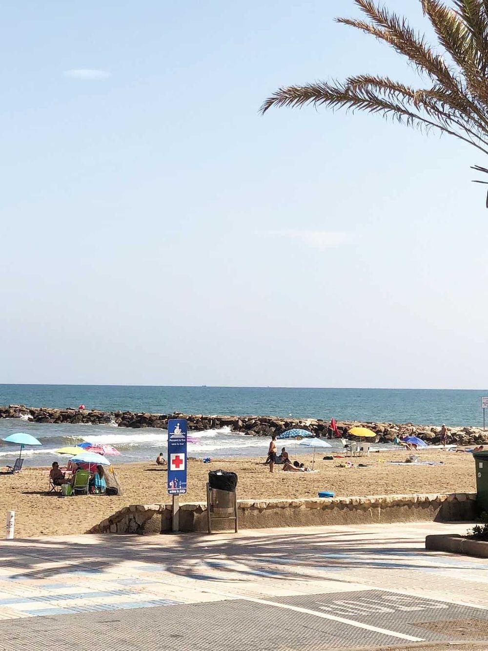 Beach scenery with umbrellas and ocean view, perfect for relaxing travel destinations.