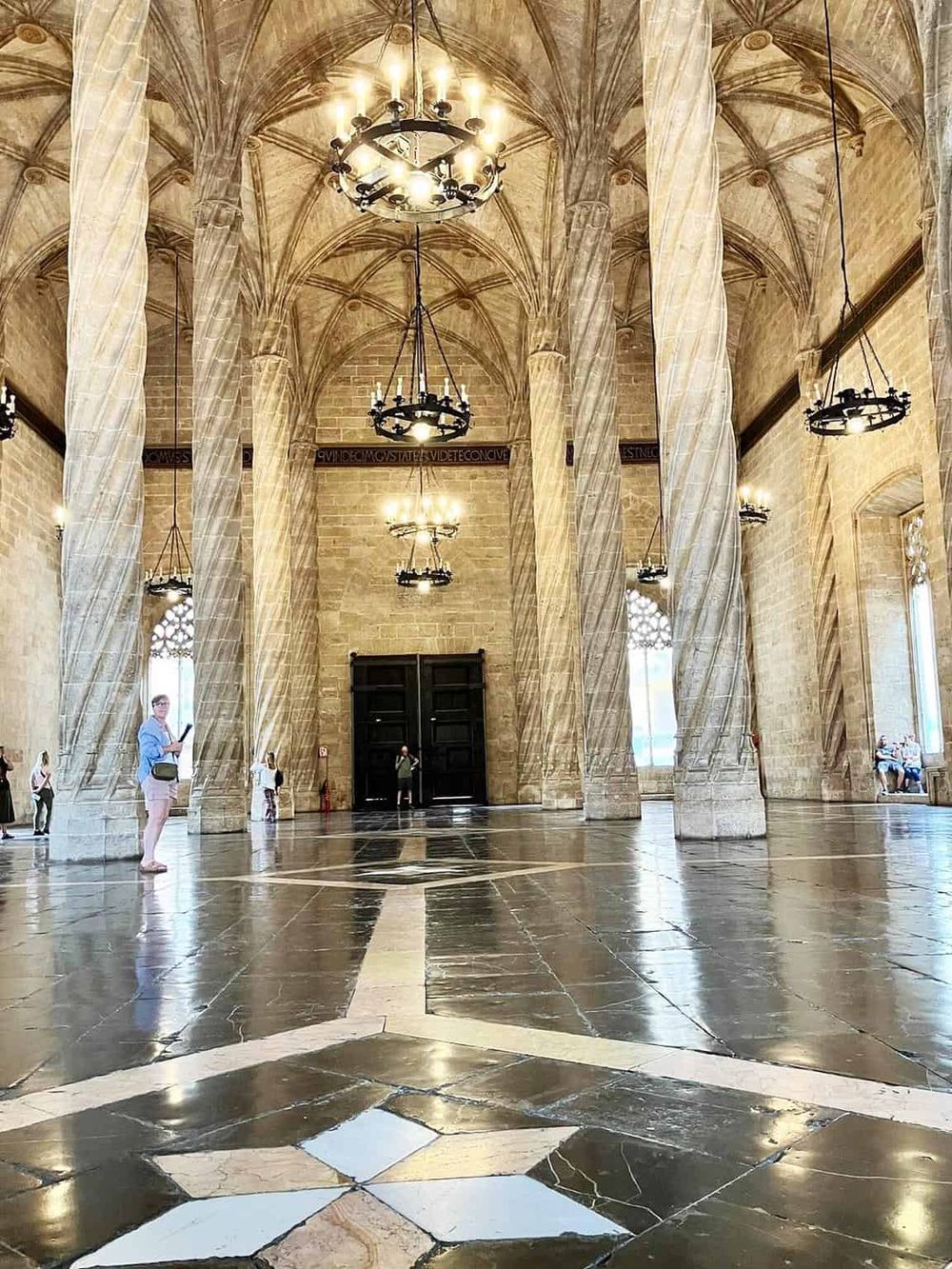 Elegant Gothic-style church interior with high vaulted ceilings and grand chandeliers.