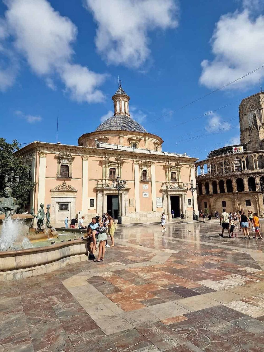 Ancient church in Piazza Navona, Rome, Italy, under a blue sky. Popular tourist destination with lively scene.