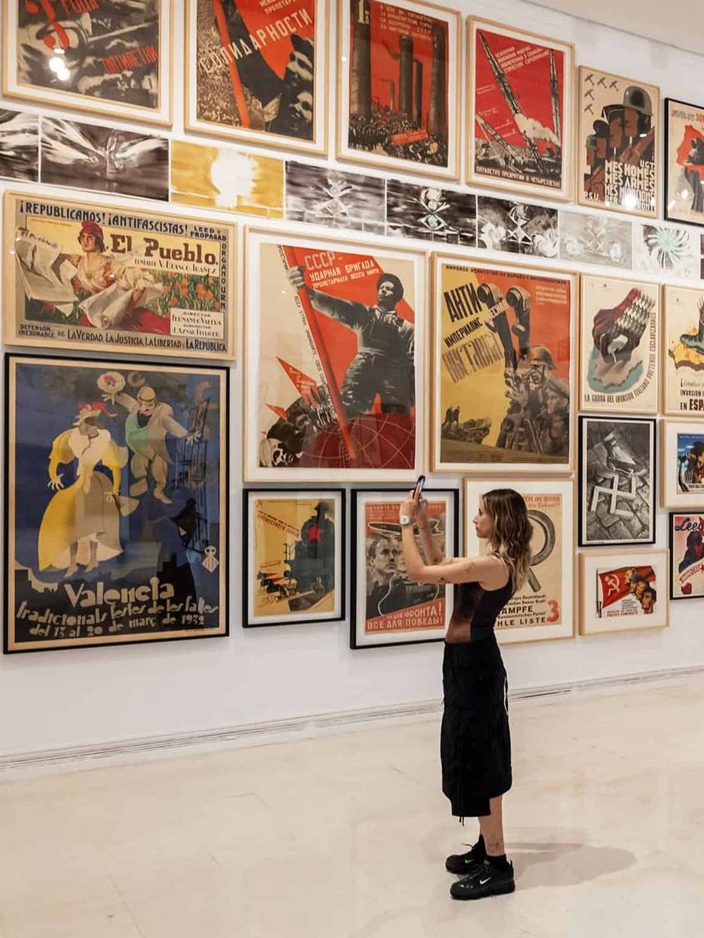 Vivid Soviet-era propaganda posters displayed at QuestForDirections art exhibit, showcasing historical artwork and cultural history.