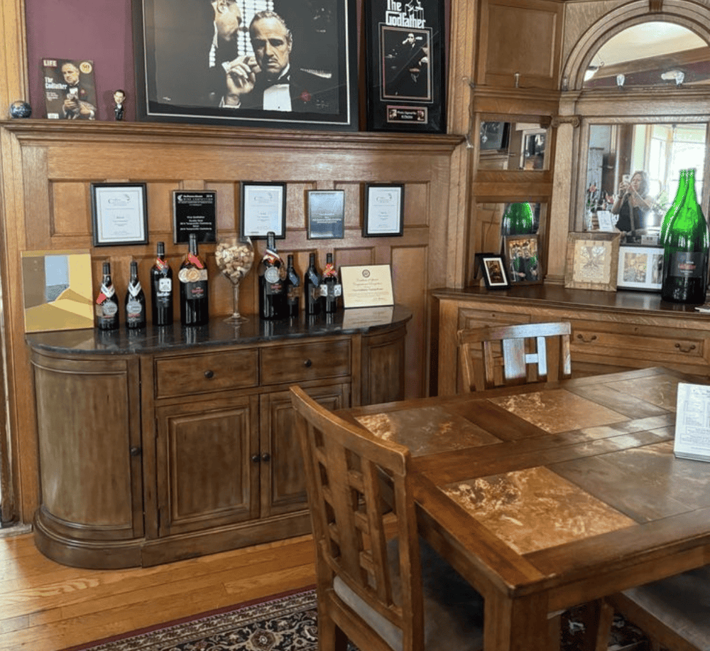 Bottle wine display with awards and framed certificates, wooden interior dining area at QuestForDirections restaurant.