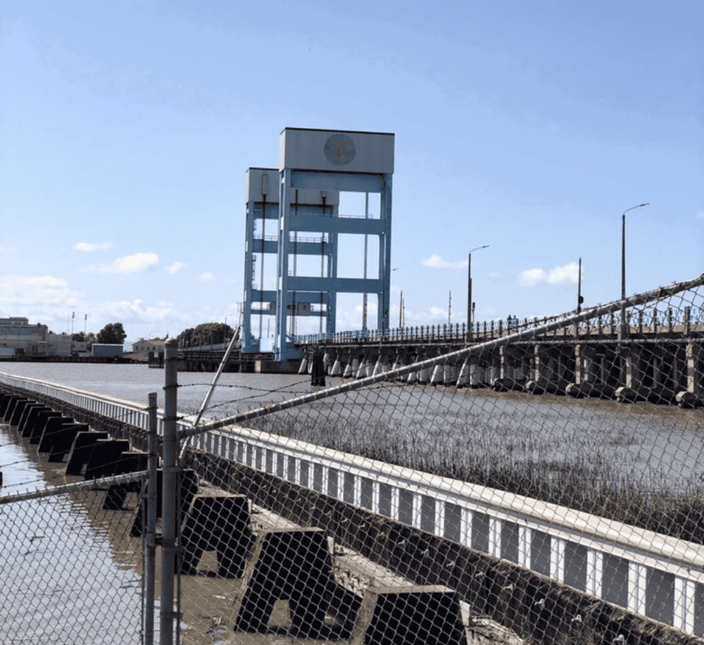 DAMS at QuestForDirections site, showing water control infrastructure and safety fencing.
