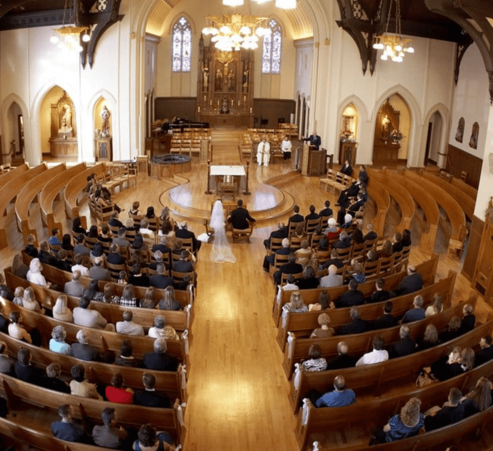 Elegant church interior with wooden pews and altar, perfect for weddings and religious ceremonies.