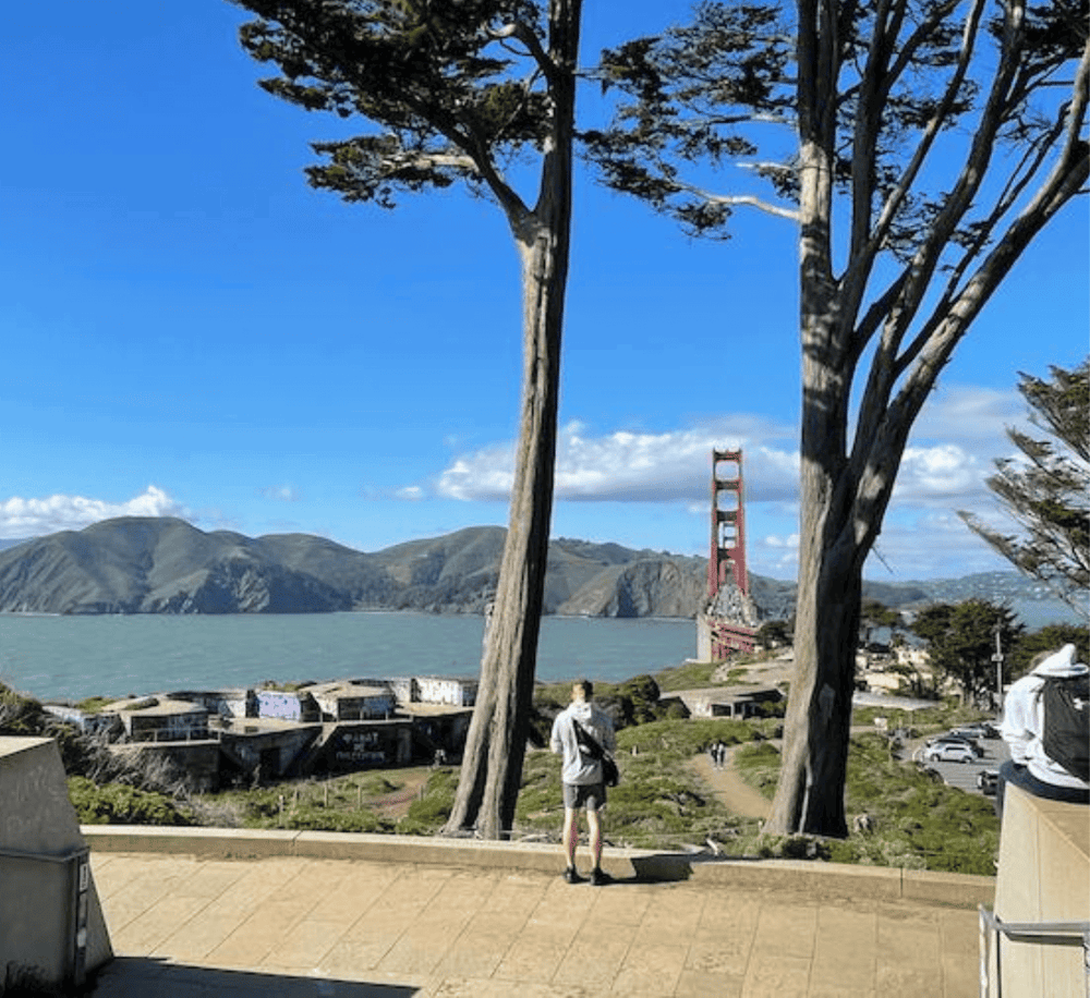 Vibrant view of the Golden Gate Bridge with scenic landscape and seaside in San Francisco, California.