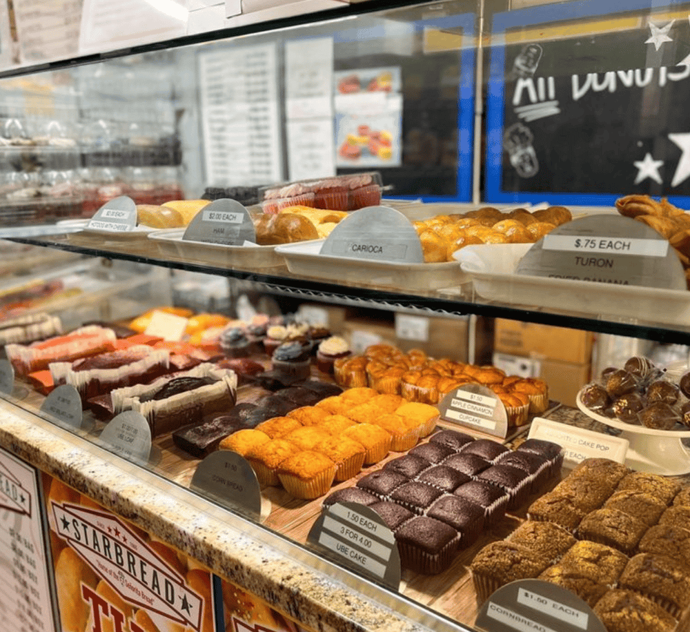 Fresh bakery desserts display at QuestForDirections bakery in the US, featuring muffins, brownies, and pastries.