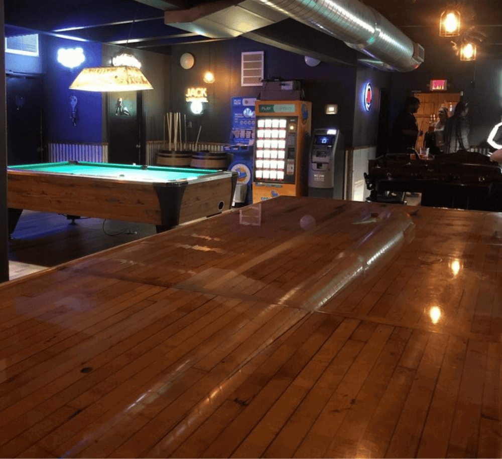 Relaxed bar with pool table, gaming machines, and casual social atmosphere at QuestForDirections.
