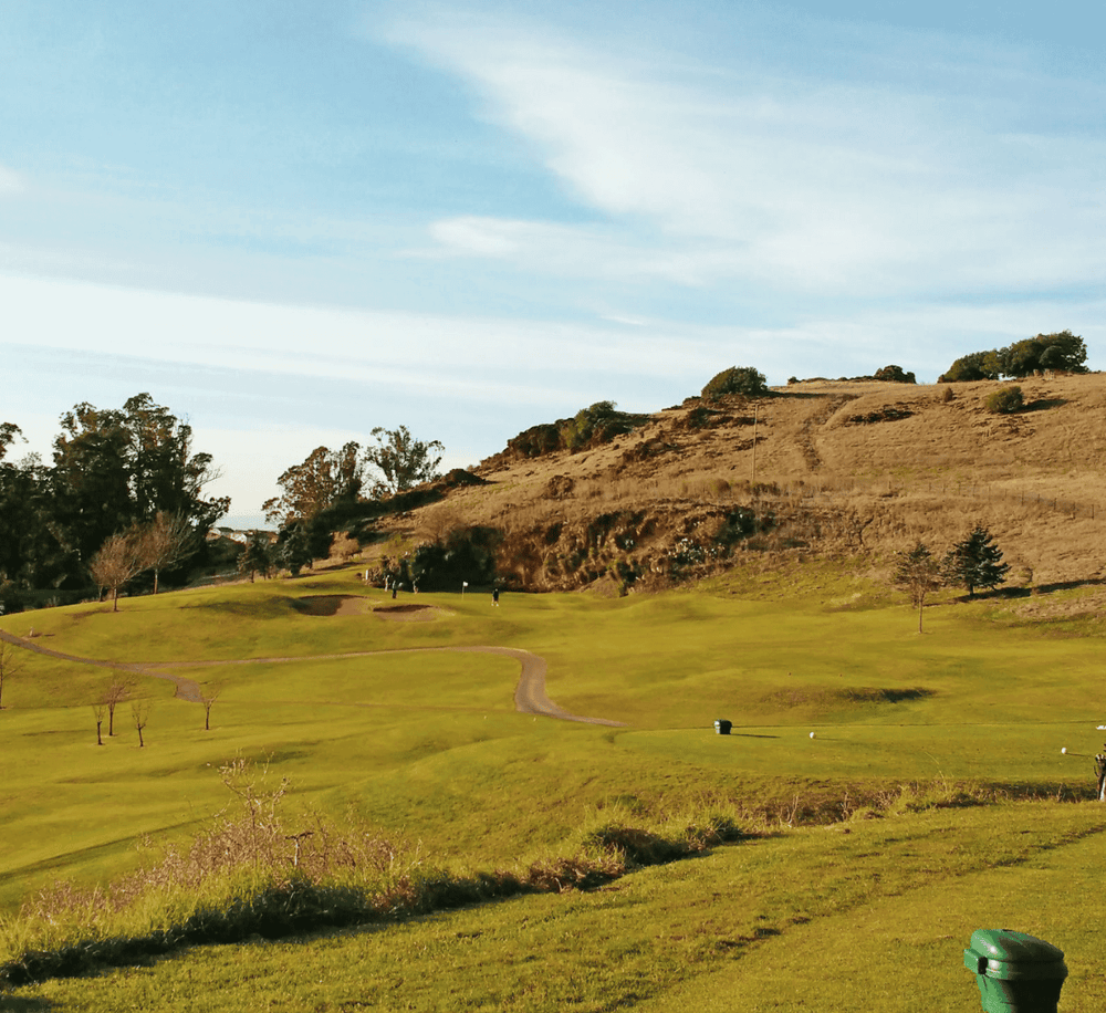 Serene golf course with rolling hills and scenic landscape at QuestForDirections location.