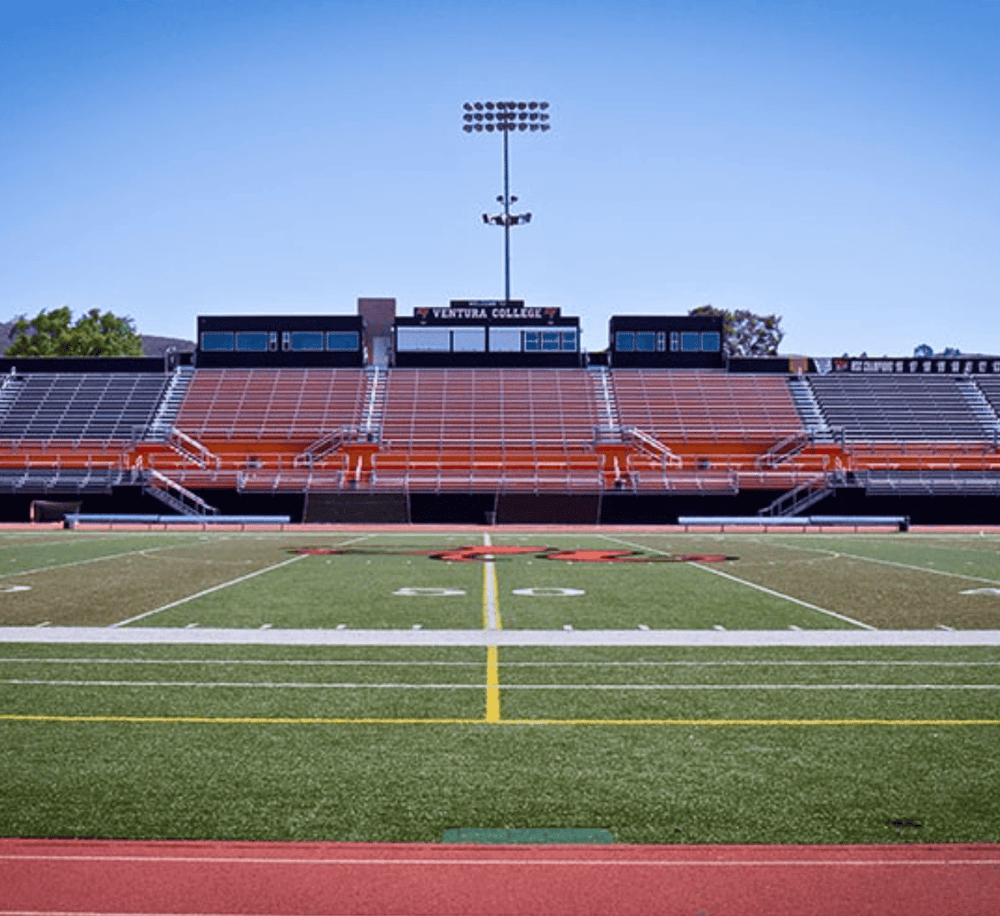 Bright football stadium at Ventura College with field and bleachers for sports events.