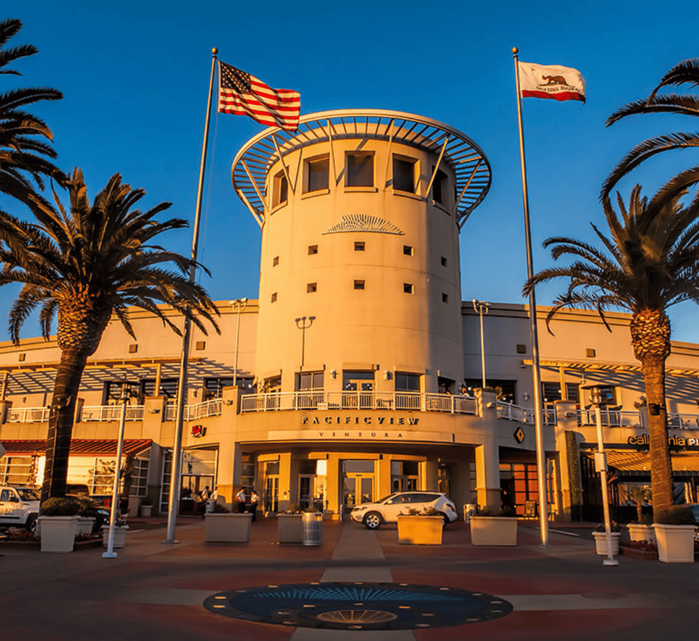 Flagship shopping center at Pacific View Ventura with iconic tower and palm trees, perfect for travel destinations.