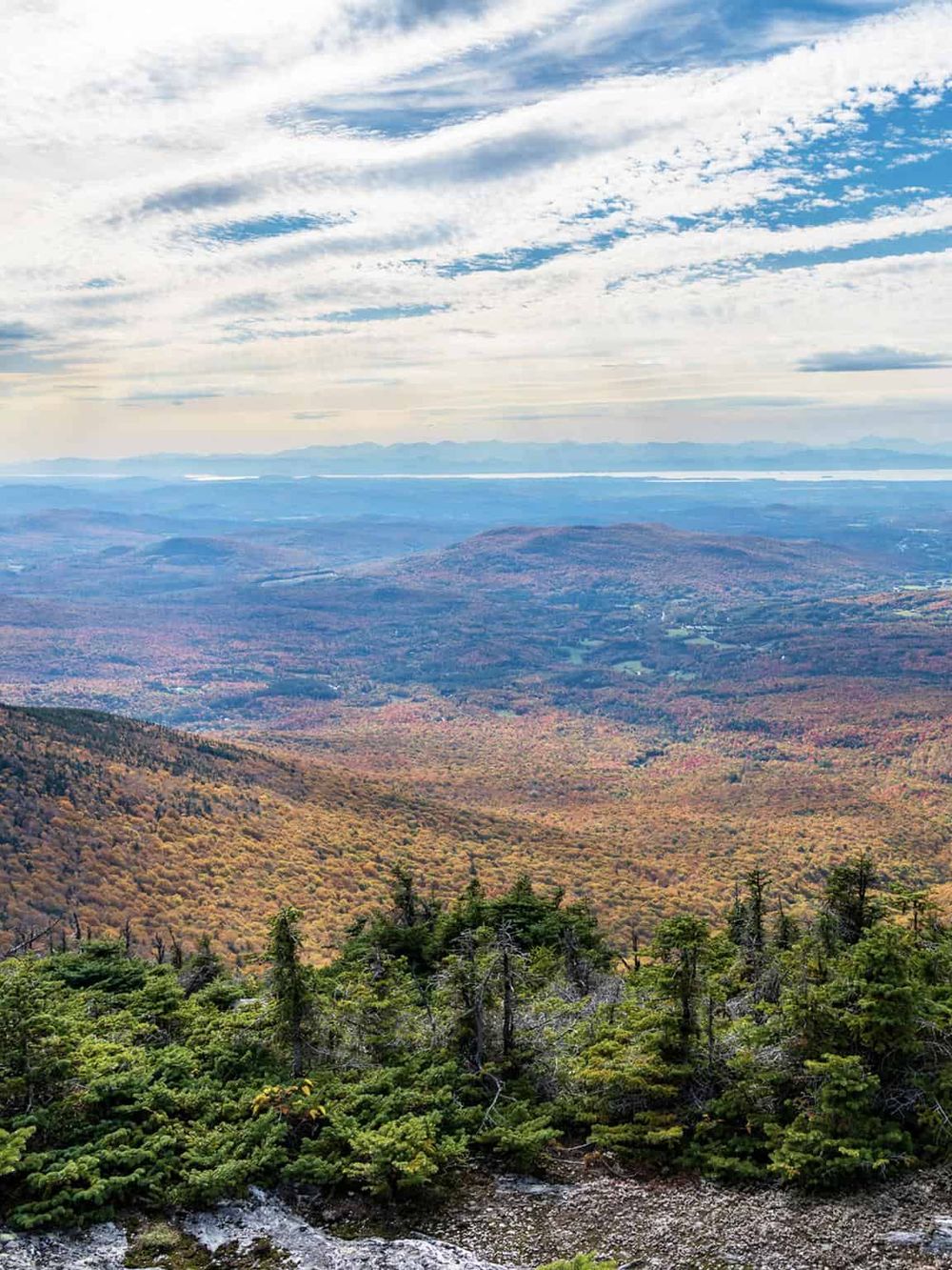 Breathtaking mountain landscape with colorful autumn foliage, vast skies, and scenic hiking trails.