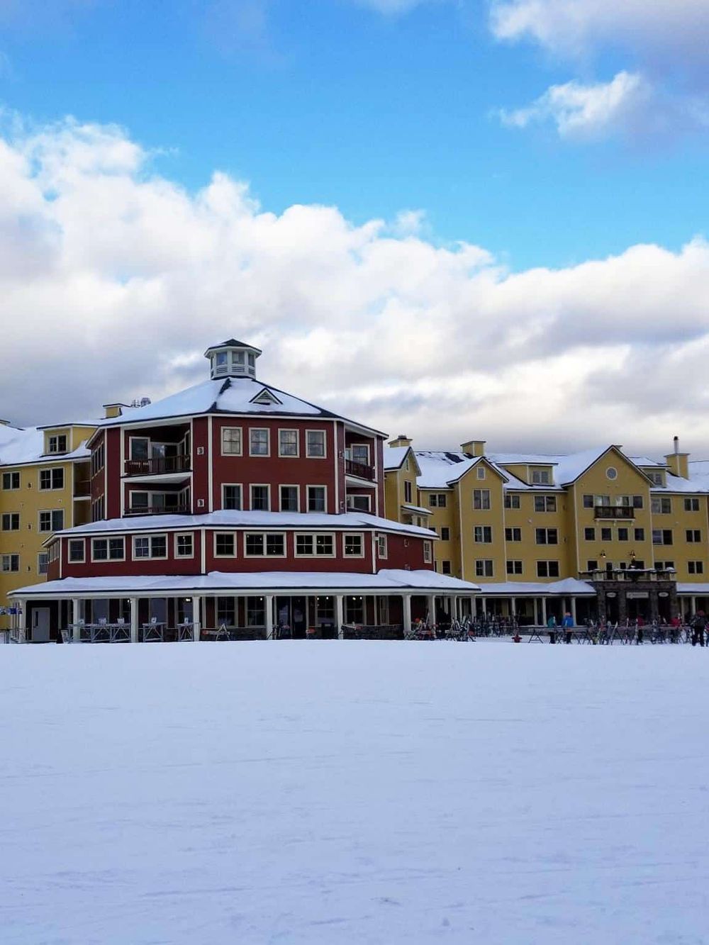 Modern resort building with colorful architecture and snow-covered grounds, ideal for winter vacation at QuestForDirections.