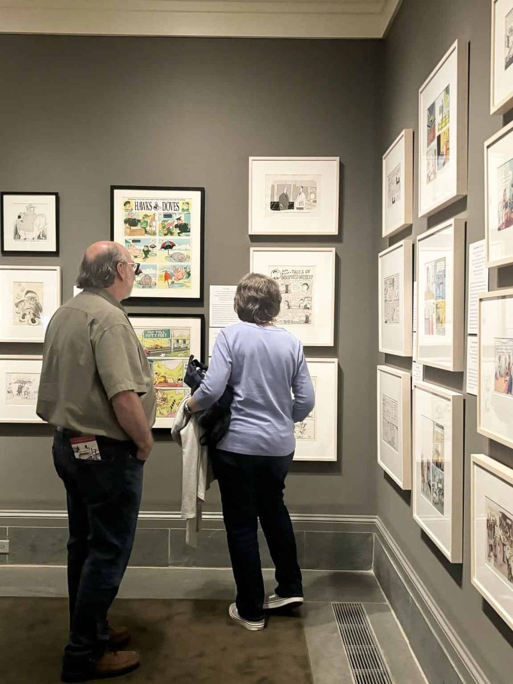 Colorful comic art gallery wall display at an art exhibition or museum.