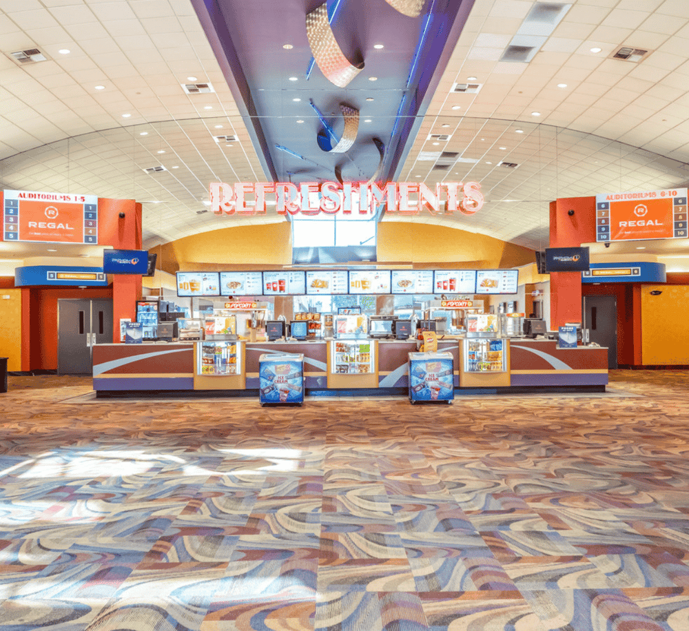 Bright indoor refreshment stand at QuestForDirections with snack selections and digital menu screens.